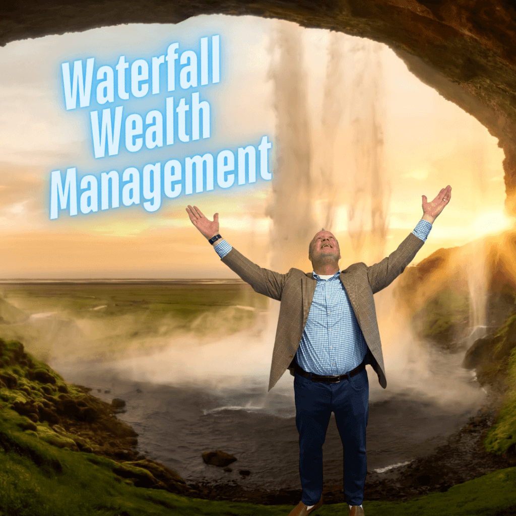 Michael Garry, financial planner and owner of Yardley Wealth Management, stands with arms raised in front of a waterfall, representing the strategic and structured approach of Waterfall Wealth Management.